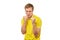 Angry young man in yellow T-shirt ready to fight with fists isolated on white background