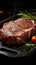 Angus steak leg piece, adorned with rosemary, awaits cooking in steel pan