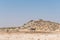 Animals at Dolomite waterhole with the Rest Camp behind