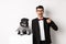 Animals, party and celebration concept. Handsome young man in suit and cute black pug in costume staring at camera
