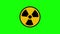 Animated radiation spinning around. Nuclear sign symbol rotate around isolated on green background. Yellow radioactive sign