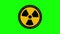 Animated radiation spinning around. Nuclear sign symbol rotate around isolated on green background. Yellow radioactive sign