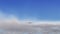 Animation of airplane flying above clouds - front view