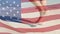 Animation of American flag waving over legs of woman walking on beach by seaside