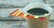 Animation of arrow on falling bar graph over overhead view of coffee cup on wooden table