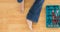 Animation of bare feet of woman in jeans sitting on wooden floor with open toolbox