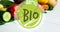 Animation of bio text in green, on green circle, over fresh vegetables on white boards