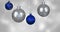 Animation of blue and silver baubles over snow falling on blue background