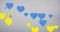 Animation of blue and yellow hearts floating over grey background