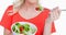 Animation of caucasian woman eating vegetable salad over white background