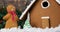 Animation of christmas gingerbread snowman and house with snow falling