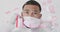 Animation of coronavirus cells and diagrams over mixed race male doctor wearing face mask