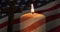 Animation of crucifix and candle moving over american flag