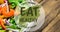 Animation of eat healthy locally grown text in green, over bowl of fresh salad on wooden boards