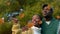 Animation of fall leaves falling over happy african american couple in autumn park