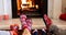 Animation of feet of african american family in christmas socks resting in front of fireplace