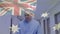 Animation of flag of australia over caucasian male doctor walking