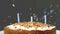 Animation of gold confetti falling over birthday cake with candles