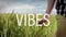 Animation of good vibes text over person walking of field