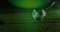 Animation of green spot of light against mid section of male soccer player practicing soccer