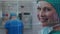 Animation of grid pattern over close-up of smiling caucasian female surgeon in hospital