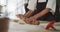 Animation of hands of asian female baker rolling sourdough for bread