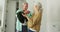 Animation of happy caucasian senior couple packing suitcase for travel