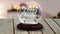 Animation of happy christmas text in snow globe on wooden table