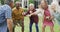 Animation of happy diverse female and male senior friends playing american football in garden