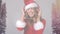 Animation of happy woman in santa hat with headphones on