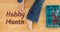 Animation of hobby month text over legs woman in jeans sitting on wooden floor with open toolbox