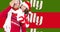 Animation of jolly text on red and green stripes and happy couple with christmas hats and present