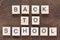 animation with lettering back to school with light wooden letters on dark wooden background