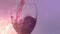 Animation of lights over rose wine pouring into glass on violet background