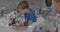 Animation of molecular structures over happy caucasian schoolboy using microscope in science class