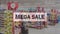 Animation of multiple mega sale text over supermarket