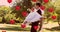 Animation of multiple red heart balloons floating over newly married couple groom carrying his bride