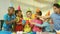 Animation of multiracial friends wearing birthday cap and doing cheers with soft drink filled glass