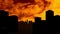 Animation of orange and yellow clouds moving in fast motion over silhouette of modern cityscape