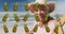 Animation of pineapple over happy senior biracial woman sunbathing on beach