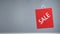 Animation of red sale bag spinning with copy space on grey background