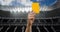 Animation of referee holding yellow card on pitch in sports stadium