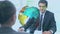 Animation of rotating globe and data, over businessman and woman shaking hands