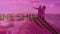 Animation of shine text over couple walking on beach into sea with pink tint