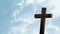 Animation of silhouette of wooden Christian cross over blue clouds on sky