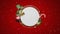 Animation of snow falling over christmas decorations around white circular sign on red background