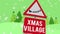 Animation of snow falling over warning sing with xmas village text in winter scenery