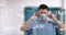 Animation of social media icons on portrait of male health worker wearing surgical mask at hospital
