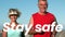 Animation of stay safe text over senior couple running on beach