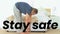 Animation of stay safe text over senior man stretching at home